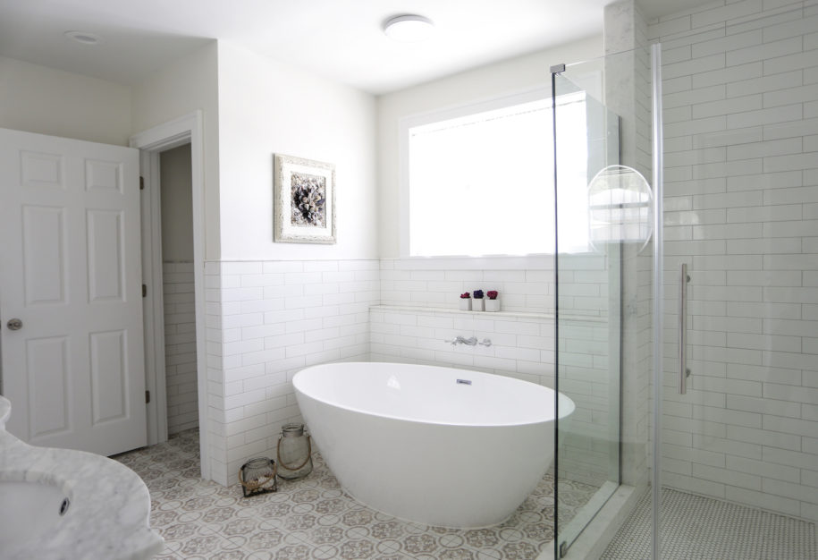 A bathroom with a large tub and walk in shower.